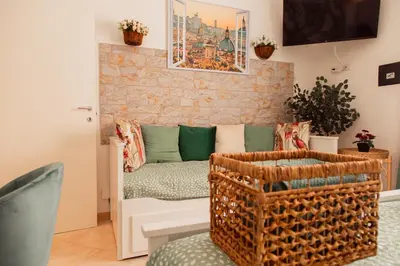a living room with a couch and a brick wall at Stefy's House in Rome