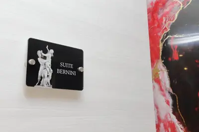 a lightswitch with a picture of a woman on it at San Pietro Luxury Rooms in Rome
