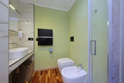 a bathroom with a toilet and a sink and a shower at San Pietro Luxury Rooms in Rome