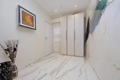 a room with white walls and a painting on the wall at San Pietro Luxury Rooms in Rome