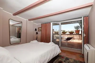 a bedroom with a bed and a large window at Spagna Prestige Apartment in Rome