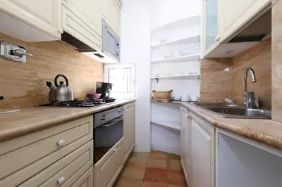 a small kitchen with a sink and a stove at Spagna Prestige Apartment in Rome