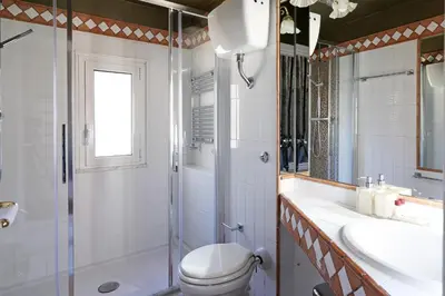 a bathroom with a toilet and a sink and a shower at Spagna Prestige Apartment in Rome