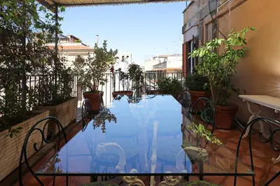 a swimming pool in the middle of a courtyard with plants at Spagna Prestige Apartment in Rome