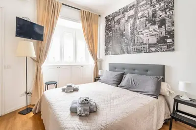 a bedroom with a bed with two stuffed animals on it at Vatican Penthouse 1 by Almond Tree in Rome