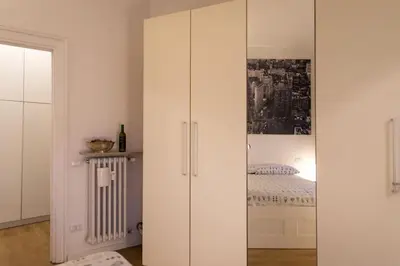 a white cabinet in a room with a bed at Vatican Penthouse 1 by Almond Tree in Rome