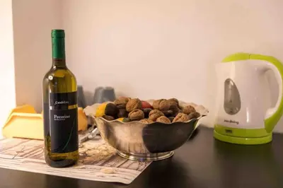 a bottle of wine next to a bowl of nuts at Vatican Penthouse 1 by Almond Tree in Rome