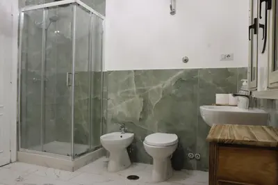 a bathroom with a shower and a toilet and a sink at archi gianicolensi apartment in Rome