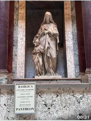 a statue of a woman with a child on a building at archi gianicolensi apartment in Rome