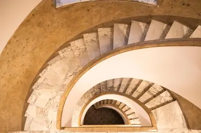 a spiral staircase in a building at archi gianicolensi apartment in Rome