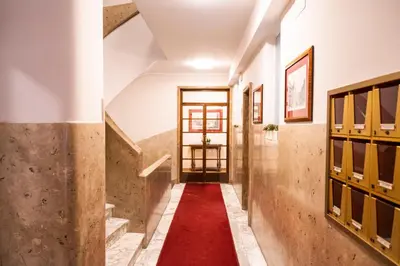 a corridor with a red carpet in a building at archi gianicolensi apartment in Rome