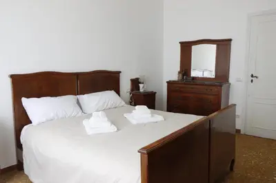 a bedroom with a bed with two towels on it at archi gianicolensi apartment in Rome