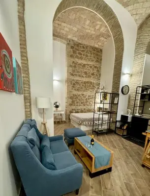 a living room with a blue couch and a table at Casa Valenziani in Rome