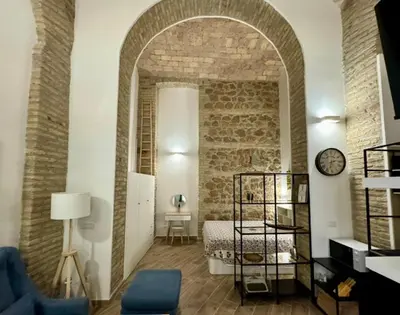 a room with a bed and a clock on a wall at Casa Valenziani in Rome