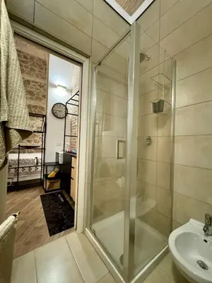 a bathroom with a glass shower and a sink at Casa Valenziani in Rome