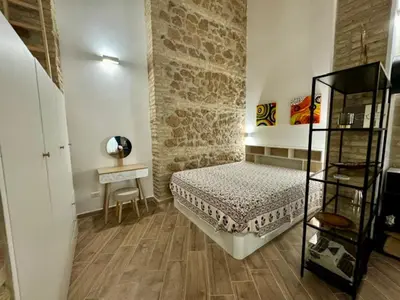 a bedroom with a bed and a table in a room at Casa Valenziani in Rome