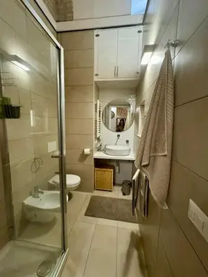 a bathroom with a sink and a toilet and a mirror at Casa Valenziani in Rome