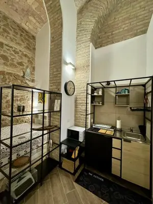 a kitchen with a counter and a clock on a wall at Casa Valenziani in Rome
