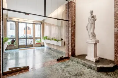 a statue of a woman on a pedestal in a lobby at The Rubens Collection in Rome