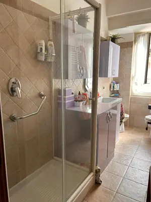 a shower with a glass door in a bathroom at casa di Francesca in Rome