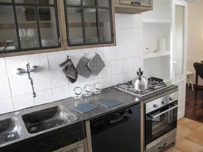 a kitchen with a sink and a stove at Interno 16 central and cosy in Rome