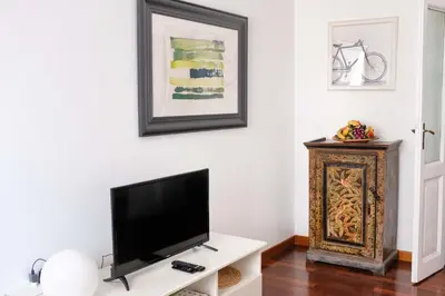 a living room with a flat screen tv on a white wall at Interno 16 central and cosy in Rome
