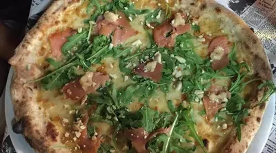 a pizza sitting on top of a white plate at Interno 16 central and cosy in Rome