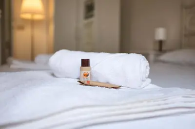 a towel and a bottle of soap on a bed at Interno 16 central and cosy in Rome
