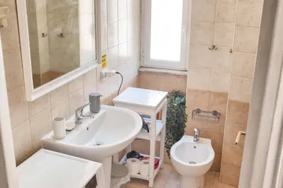 a bathroom with a sink and a toilet at Interno 16 central and cosy in Rome