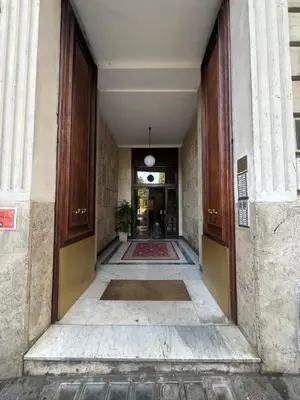 an empty hallway leading to a building with a hallway at Savoia design apartment with terrace - Rome center in Rome