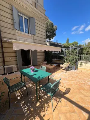 a patio with a table and chairs in front of a house at Savoia design apartment with terrace - Rome center in Rome