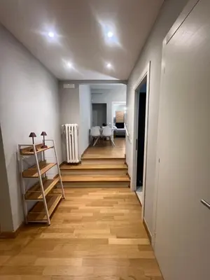 a hallway with wooden floors and white walls at Savoia design apartment with terrace - Rome center in Rome