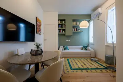 a living room with a table and a couch at Properzio 37 in Rome
