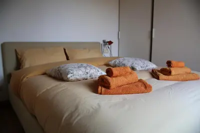 two towels on a bed with two stuffed animals at Casa del Drago in Trastevere in Rome