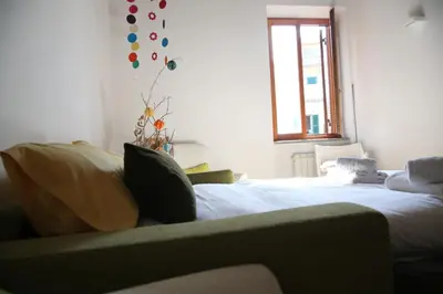 a living room with a bed and a couch at Casa del Drago in Trastevere in Rome