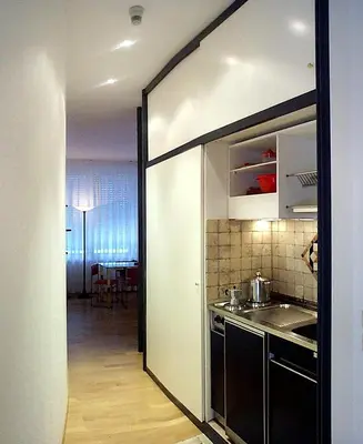 a kitchen with a door open to a dining room at Pràti Home in Rome