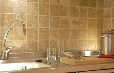 a kitchen counter with a sink with glasses on it at Pràti Home in Rome