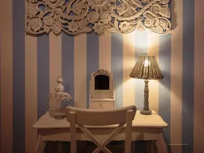 a table with a chair and a lamp and a desk with a computer at Appartamento familiare nel cuore di Roma in Rome