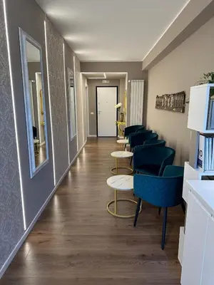 a waiting room with blue chairs and a corridor at Domus Paolina Ostiense in Rome