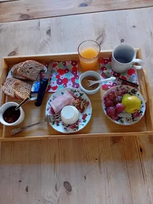 a tray with breakfast foods and a cup of orange juice at Bed & Breakfast da Monica in Rome