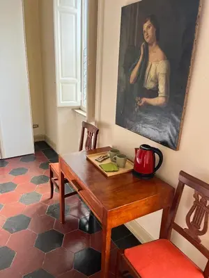 a dining room with a table and a painting on the wall at Bed & Breakfast da Monica in Rome