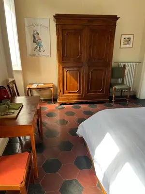 a bedroom with a bed and a wooden cabinet at Bed & Breakfast da Monica in Rome