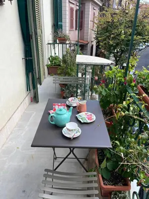 a table with two cups and a teapot on a patio at Bed & Breakfast da Monica in Rome