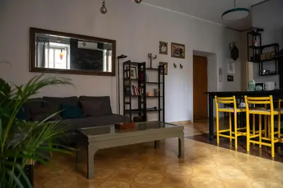 a living room with a couch and a table and chairs at Artist Vatican House in Rome