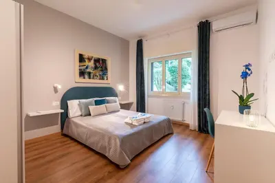 a small bedroom with a bed and a window at Vatican Oasis - Free Parking, 4-6 pax, 2 bedrooms in Rome