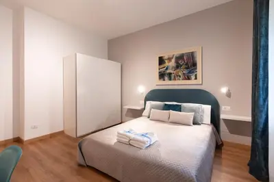 a bedroom with a bed with towels on it at Vatican Oasis - Free Parking, 4-6 pax, 2 bedrooms in Rome