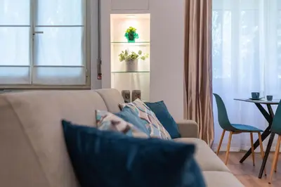 a person laying on a couch in a living room at Vatican Oasis - Free Parking, 4-6 pax, 2 bedrooms in Rome