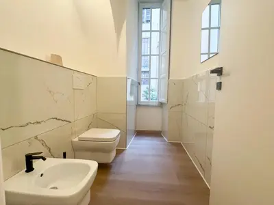 a white bathroom with a sink and a toilet at Montezebio Boutique Rooms in Rome