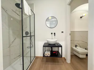 a bathroom with a sink and a shower at Montezebio Boutique Rooms in Rome