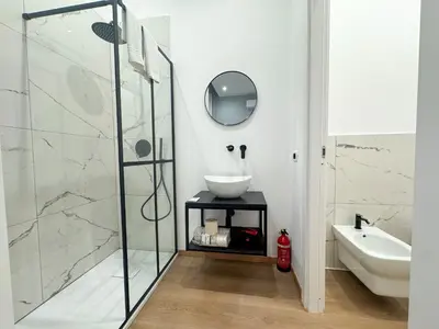 a bathroom with a sink and a shower at Montezebio Boutique Rooms in Rome